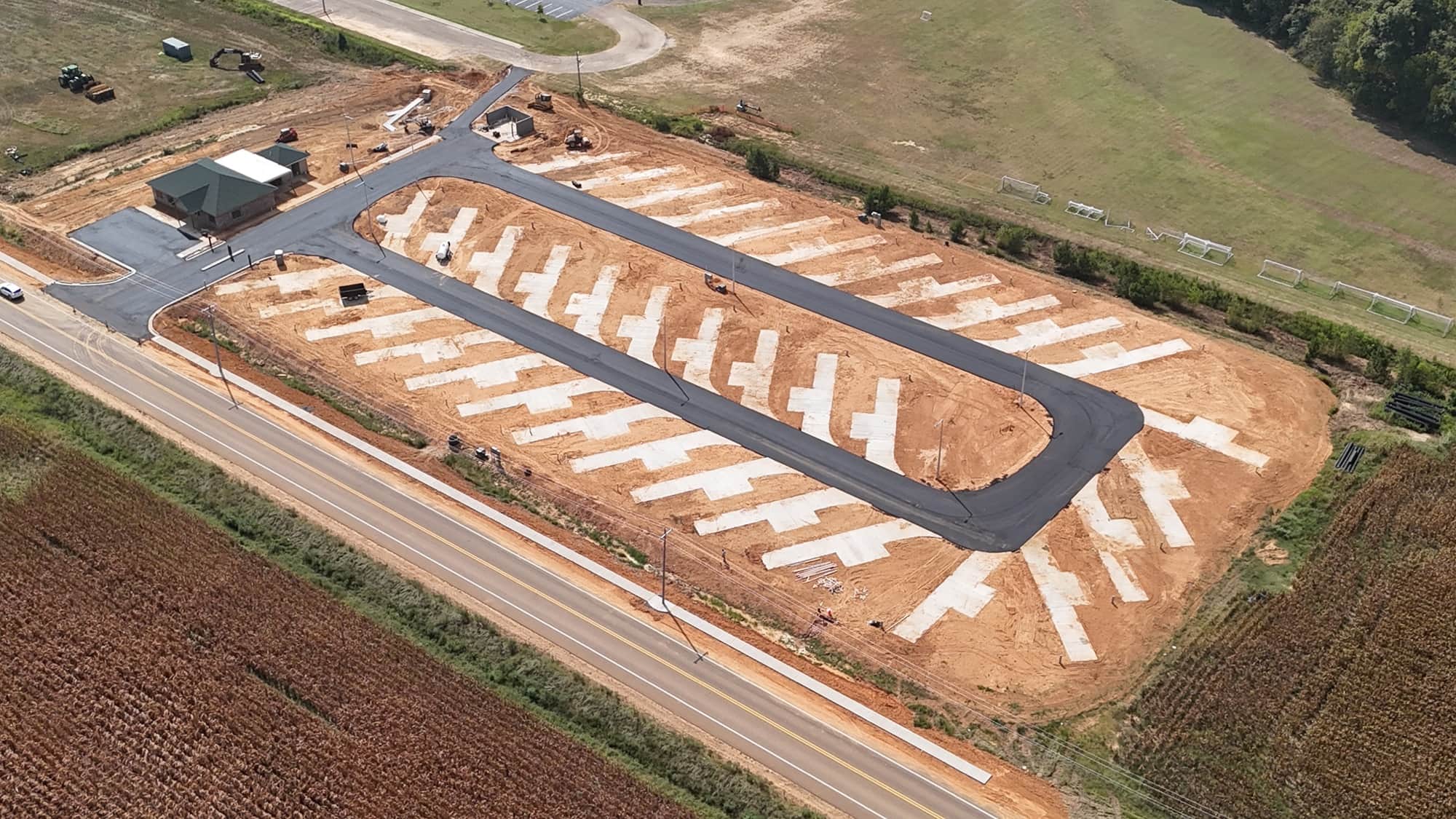 Evergreens RV Park from the air: the paved loop road, rows of concrete pads, and the office at the entrance