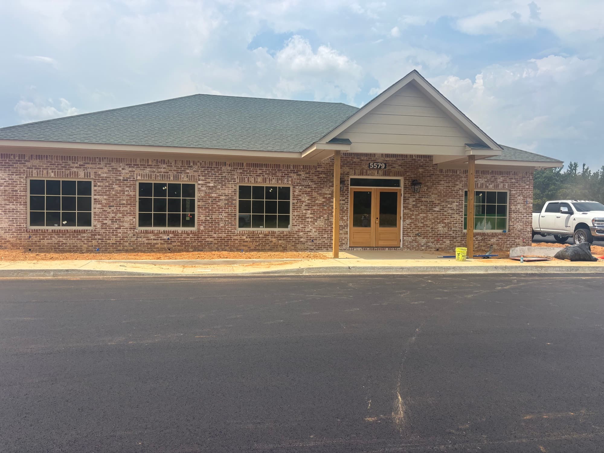 Front of the Evergreens RV Park office — brick, double doors, and a covered porch at 5579 Pat Patterson Parkway